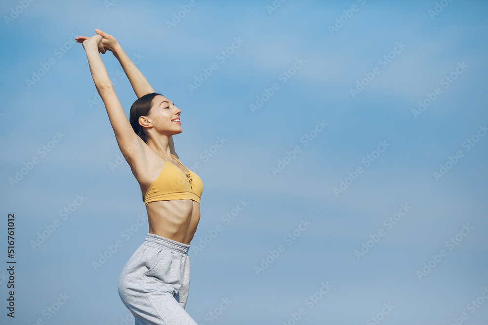 Cute girl training on a sky backgroung Cute girl training on a sky backgroung