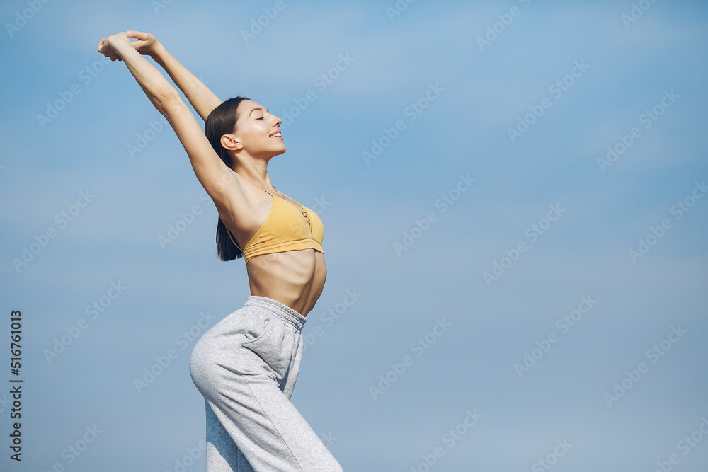 Cute girl training on a sky backgroung Cute girl training on a sky backgroung