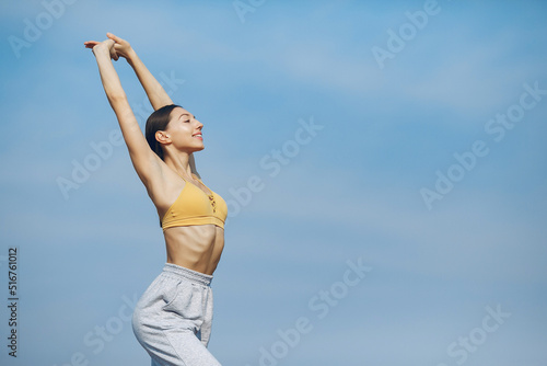 Cute girl training on a sky backgroung © prostooleh