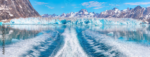 Waves of blue sea behind the speedboat water - Background water surface behind of fast moving motor boat across the     Knud Rasmussen Glacier near Kulusuk - Greenland  East Greenland 
