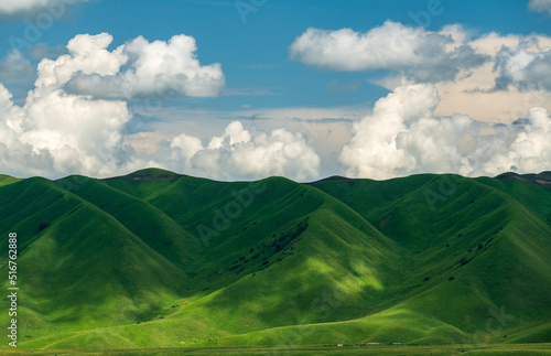 clouds shadow on green mountains