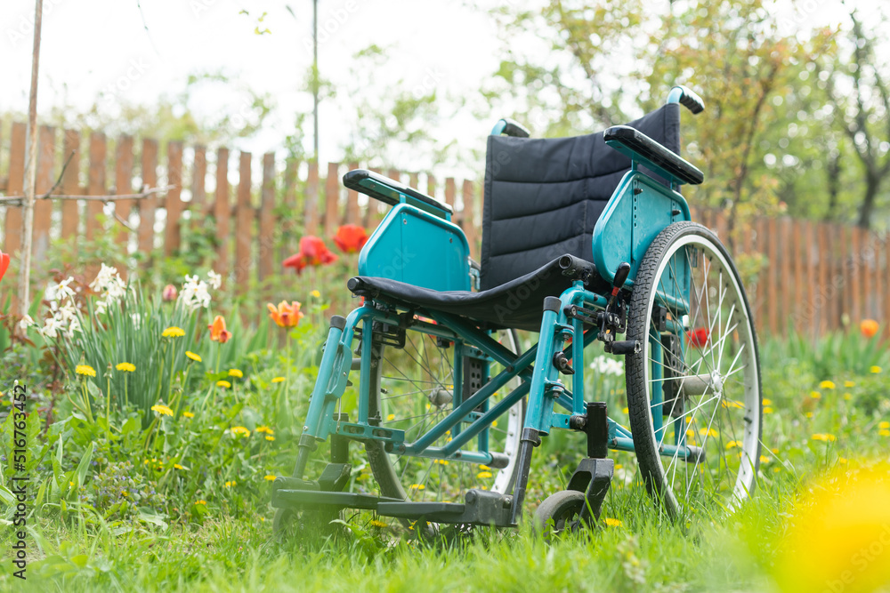 old wheelchair in the garden.
