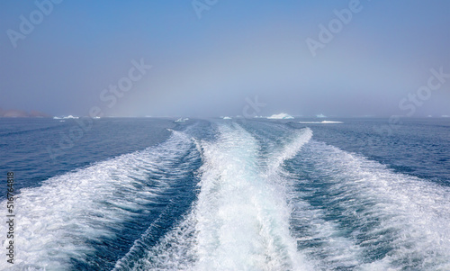 Waves of blue sea behind the speedboat water - Background water surface behind of fast moving motor boat across the Melting icebergs by the coast of Greenland - Greenland  © muratart