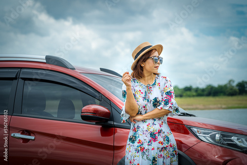 Quadro em tela A woman and her trusty red car traveling to travel.