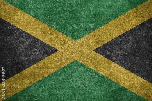 Old leather shabby background in colors of national flag. Jamaica