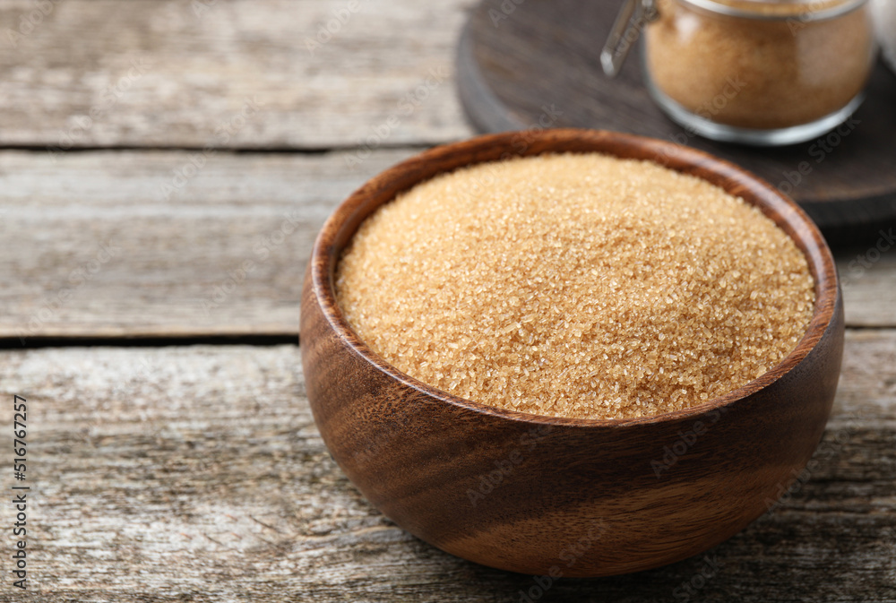 Brown sugar in bowl on wooden table. Space for text Brown sugar in bowl on wooden table. Space for text
