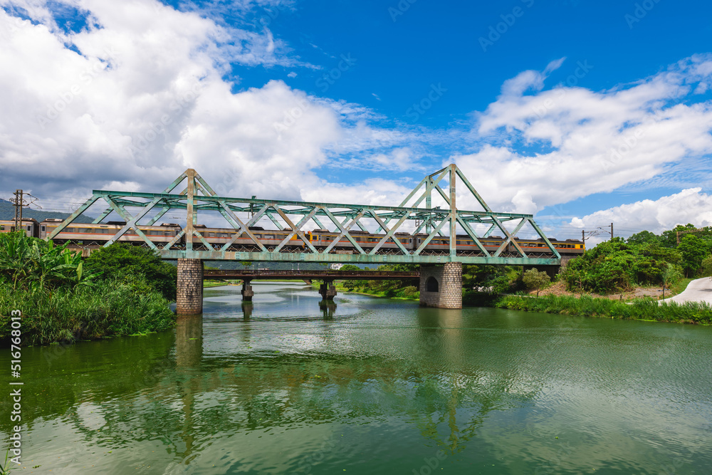 Train pass the iron bridge at dongshan river eco park in yilan, taiwan Train pass the iron bridge at dongshan river eco park in yilan, taiwan