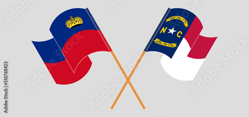 Crossed and waving flags of Liechtenstein and The State of North Carolina