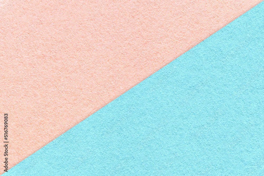 Fototapeta premium Texture of craft light blue and pink paper background, half two colors, macro. Vintage dense kraft rose cardboard.