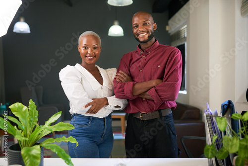 Two Black co-founders pose with arms crossed with their new business photo