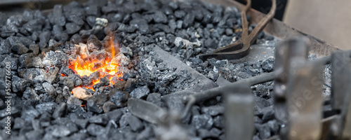 Vászonkép Close-up detail old medieval blacksmith furnace with hot burning coal flame forge iron metal