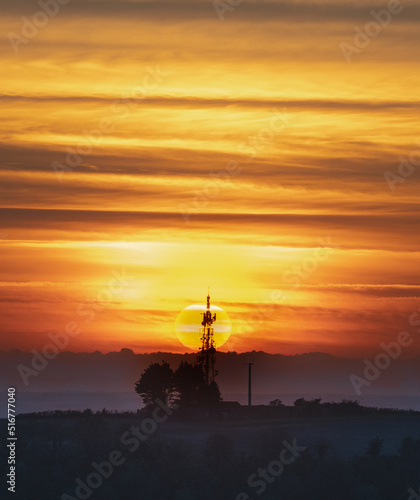 A stunning orange sunset against a radio mast