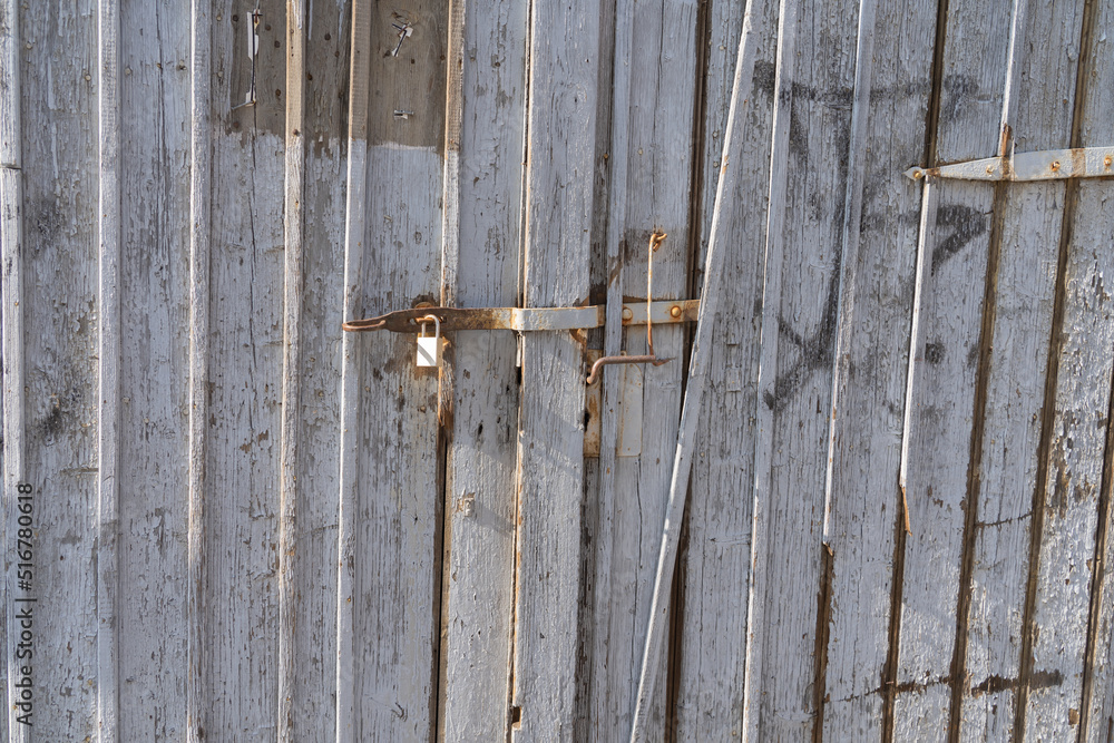 Old weathered wooden gate with bolt and lock Old weathered wooden gate with bolt and lock