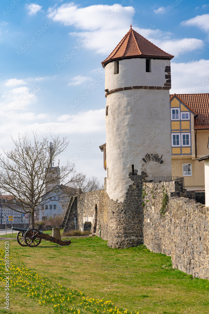 Old watchtower with historic cannon in front of the old city wall of Homberg Efze in Germany