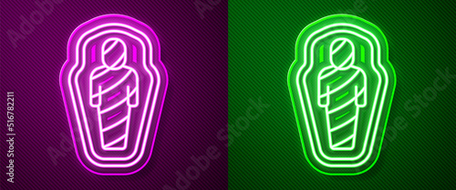 Glowing neon line Egypt mummy in sarcophagus icon isolated on purple and green background. Vector