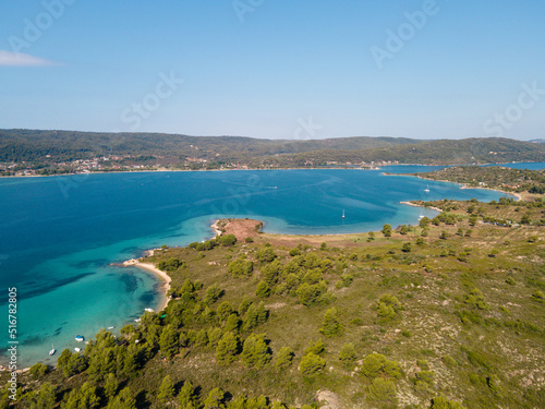 Aerial view of Diaporos Island in Halkidiki, Greece, Small islands with blue lagoon in the Aegean sea during summer holiday season © Miro Nenchev