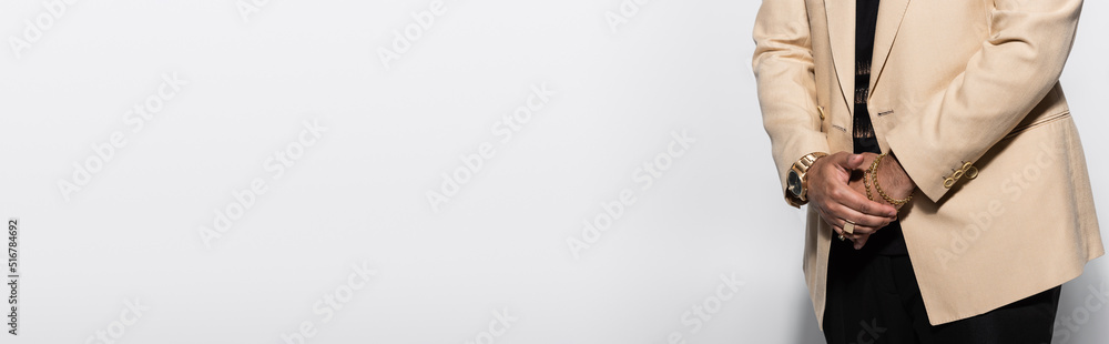 cropped view of hip hop performer with wristwatch and rings standing on grey, banner. - obrazy, fototapety, plakaty 