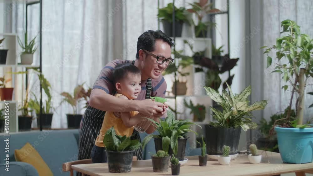 Happy Asian Man With Son Watering Plants At Home
Happy Asian Man With Son Watering Plants At Home