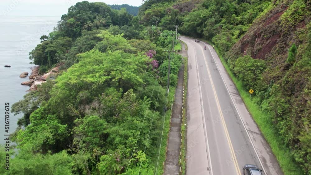 Fast Aerial flying over road along coast of Ubatuba on partly cloudy day, Brazil Fast Aerial flying over road along coast of Ubatuba on partly cloudy day, Brazil