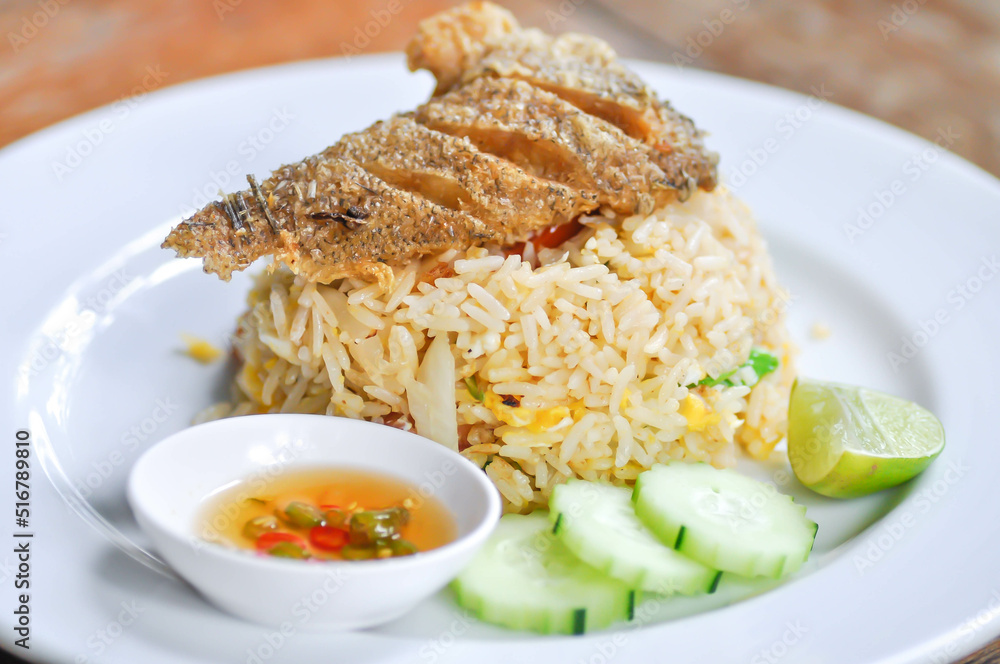 stir fried rice or fried rice with fried fish topping , fish and rice stir fried rice or fried rice with fried fish topping , fish and rice