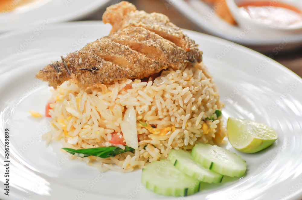 stir fried rice or fried rice with fried fish topping , fish and rice stir fried rice or fried rice with fried fish topping , fish and rice