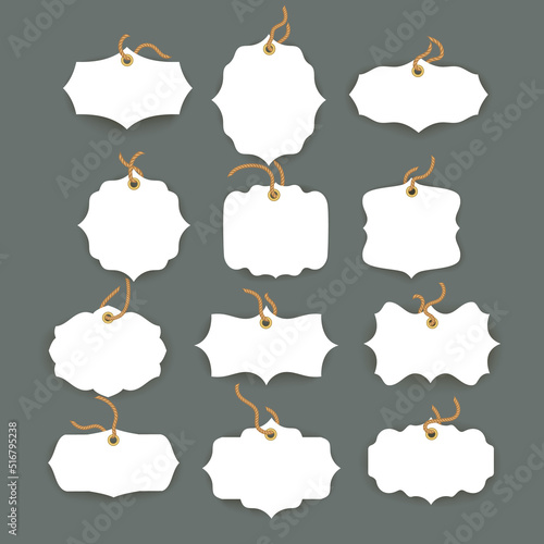 Blank white paper price tags or gift tags in different shapes. Set of labels with cord.