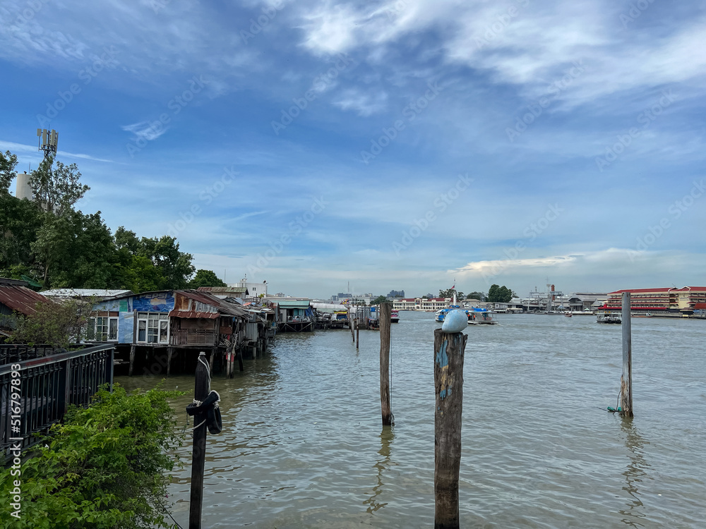 Bangkok, Thailand – June 18, 2022: Tha Maharaj Ferry Pier and Shophouses along the Chao Phraya River in Bangkok, Thailand, Asia