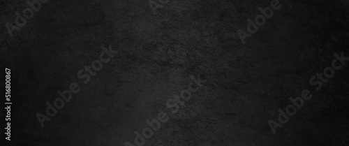 Black abstract lava stone texture background, dark black rough grainy stone or concrete wall texture background, black background with faint texture and bright center and black vignette border. 