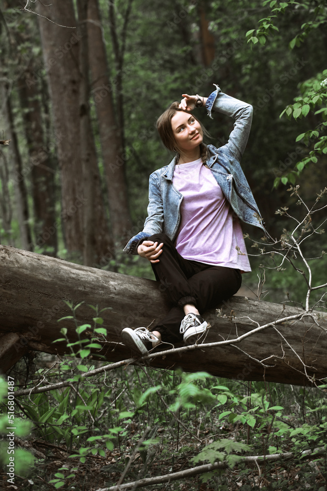 portrait of a beautiful tourist girl dressed in casual, comfortable clothes on a hike in a green forest portrait of a beautiful tourist girl dressed in casual, comfortable clothes on a hike in a green forest