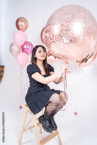 lovely young asian women with balloons on their birthday