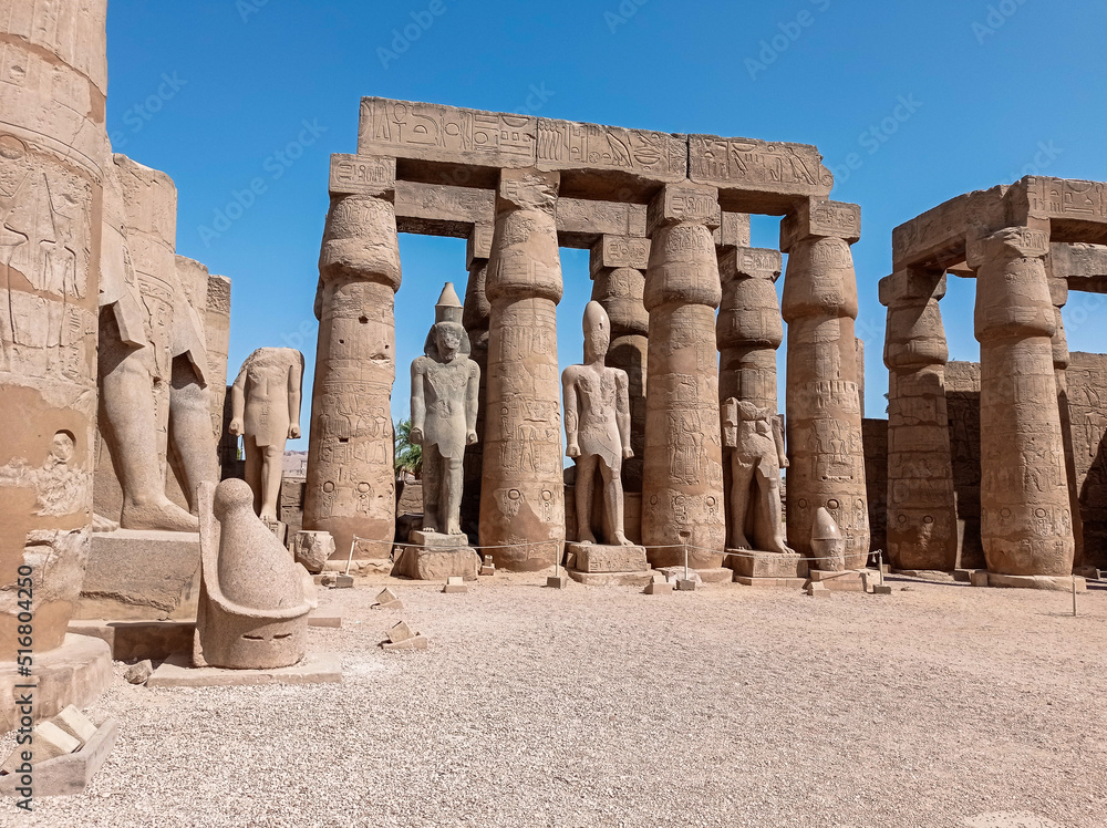 Ruins of an ancient egyptian temple with columns full of hieroglyphs in Egypt