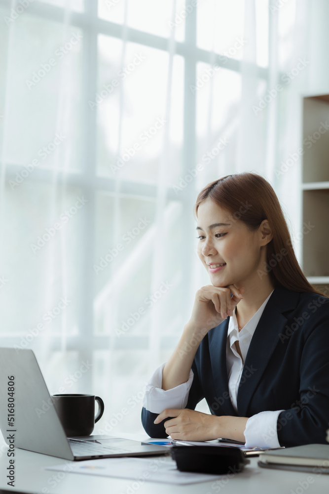 Business woman working in a private office, she is reviewing the company's financial documents sent from the finance department before he takes it to a meeting with a business partner. Financial conce Business woman working in a private office, she is reviewing the company's financial documents sent from the finance department before he takes it to a meeting with a business partner. Financial conce