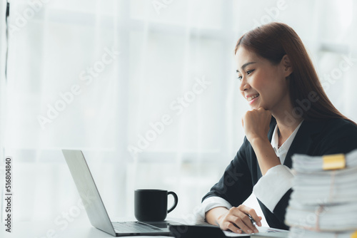 Business woman working in a private office  she is reviewing the company s financial documents sent from the finance department before he takes it to a meeting with a business partner. Financial conce