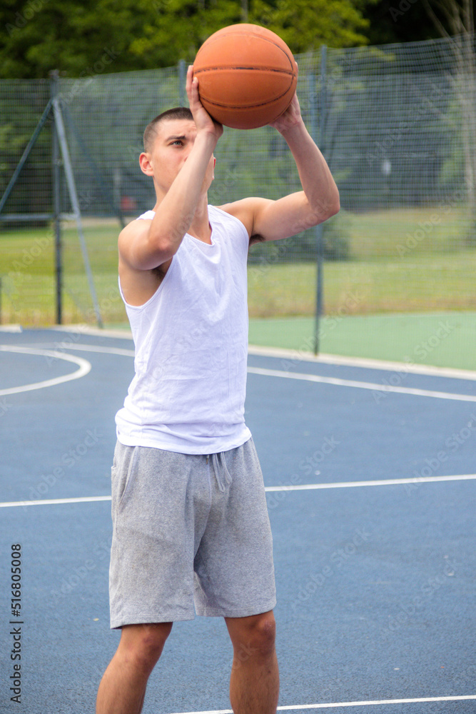A Nineteen Year Old Teenage Boy Playing Basketball A Nineteen Year Old Teenage Boy Playing Basketball
