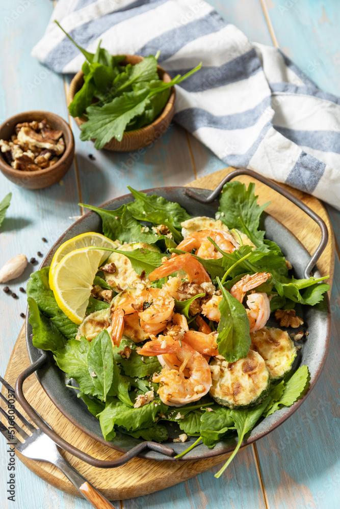 Healthy food concept. Diet summer salad plate. Shrimps salad with arugula, grilled zucchini and walnut. Healthy food concept. Diet summer salad plate. Shrimps salad with arugula, grilled zucchini and walnut.