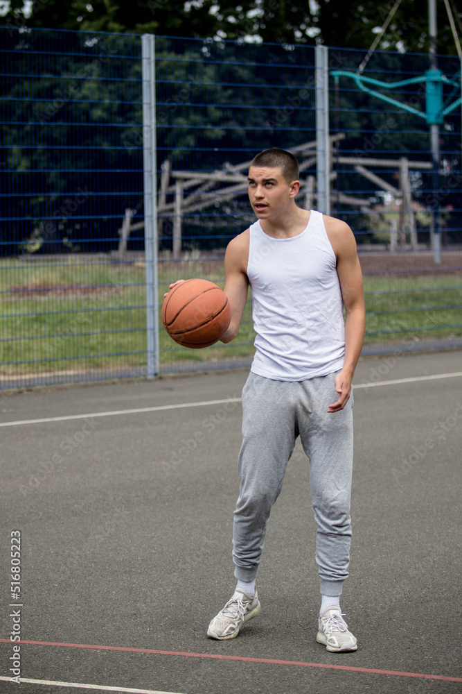 A Nineteen Year Old Teenage Boy Playing Basketball A Nineteen Year Old Teenage Boy Playing Basketball