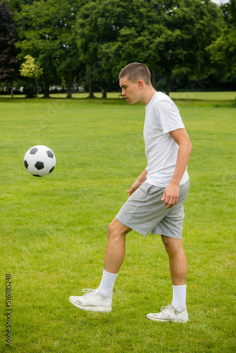 A Nineteen Year Old Teenage Boy Playing Football in A Public Park © Ben Gingell