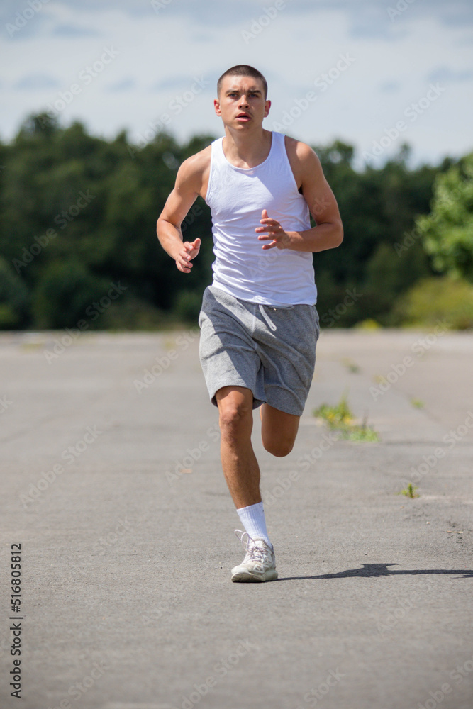 A Nineteen Year Old Teenage Boy Jogging In A Public Park A Nineteen Year Old Teenage Boy Jogging In A Public Park