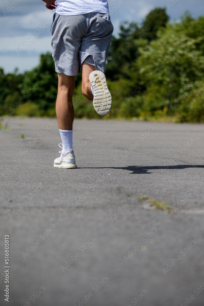 A Nineteen Year Old Teenage Boy Jogging In A Public Park A Nineteen Year Old Teenage Boy Jogging In A Public Park