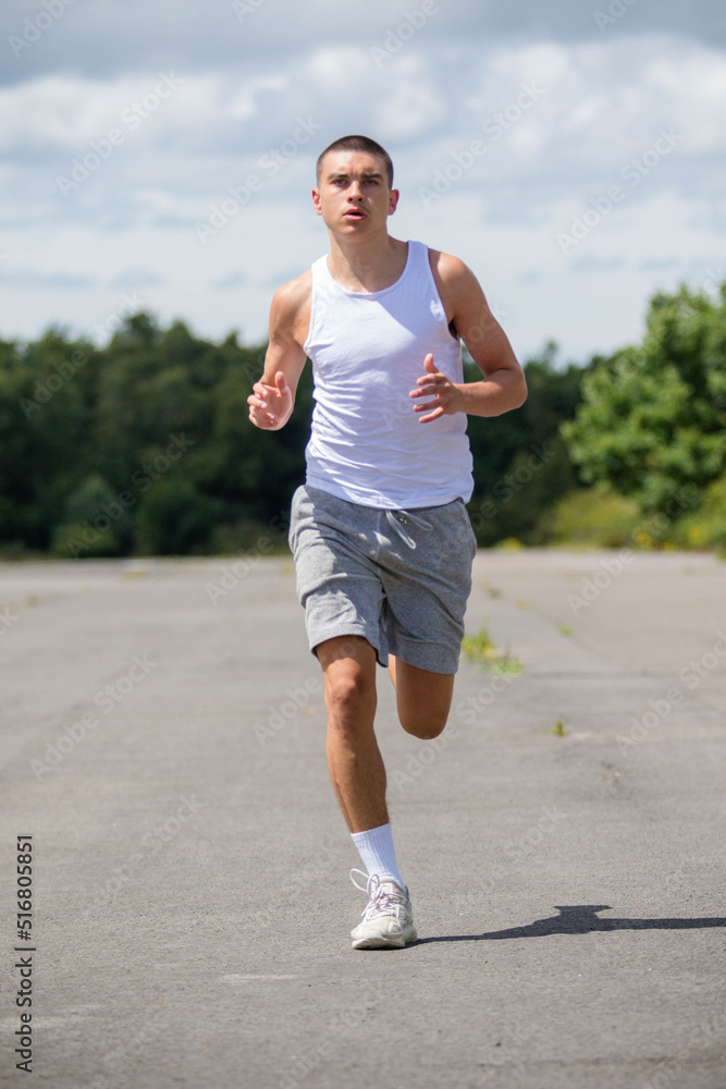 A Nineteen Year Old Teenage Boy Jogging In A Public Park A Nineteen Year Old Teenage Boy Jogging In A Public Park