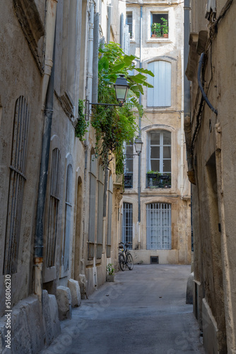 Fototapeta Naklejka Na Ścianę i Meble -  Scenic urban landscape of typical narrow street with ancient buildings in the historic center of Montpellier, France