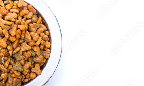 Round metal bowl for pets with dry food. Isolated on white background. View from above. Part of a plate