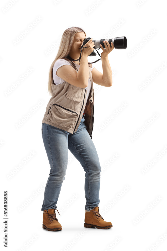 Full length shot of a female photo journalist taking a photo with a camera Full length shot of a female photo journalist taking a photo with a camera