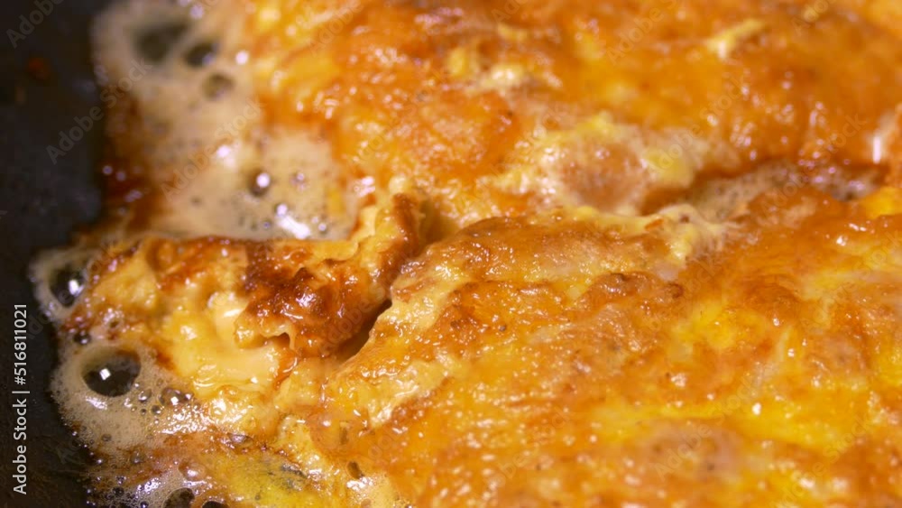 A meat chop is fried in a pan. A pork dish is prepared in the kitchen. Food fried in oil and butter and fat. A meat chop is fried in a pan. A pork dish is prepared in the kitchen. Food fried in oil and butter and fat.