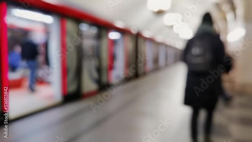 Unrecognised people in underground. Metro station inside. Person go to work or holiday. Winter clothes. Empty subway