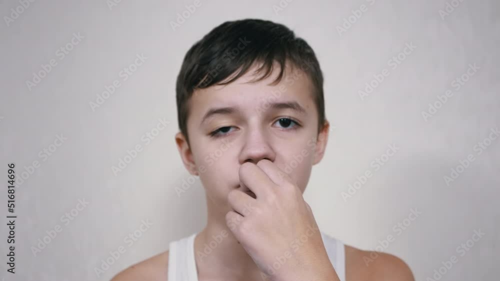 Handsome Caucasian Boy Chewing Gum Looking at the Camera. A happy child
