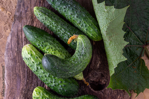 garden harvest - cucumbers lie on an old wooden board
