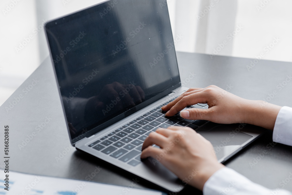 A woman typing on a laptop keyboard, she is filling out her credit card information to pay for an order on an Internet shopping site. Online shopping and credit card payment concept. A woman typing on a laptop keyboard, she is filling out her credit card information to pay for an order on an Internet shopping site. Online shopping and credit card payment concept.