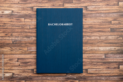 Printed and bound Bachelorarbeit (bachelor thesis) in Germany. Book with a blue cover to graduate from a German university with a bachelor degree. Finish studies with a project.