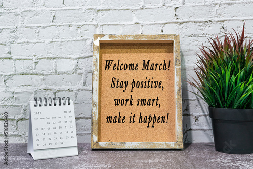 Inspirational and motivational quote on wooden frame and March 2022 calendar. photo